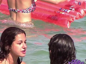 Two italian girls playing under the water on the topless beach
